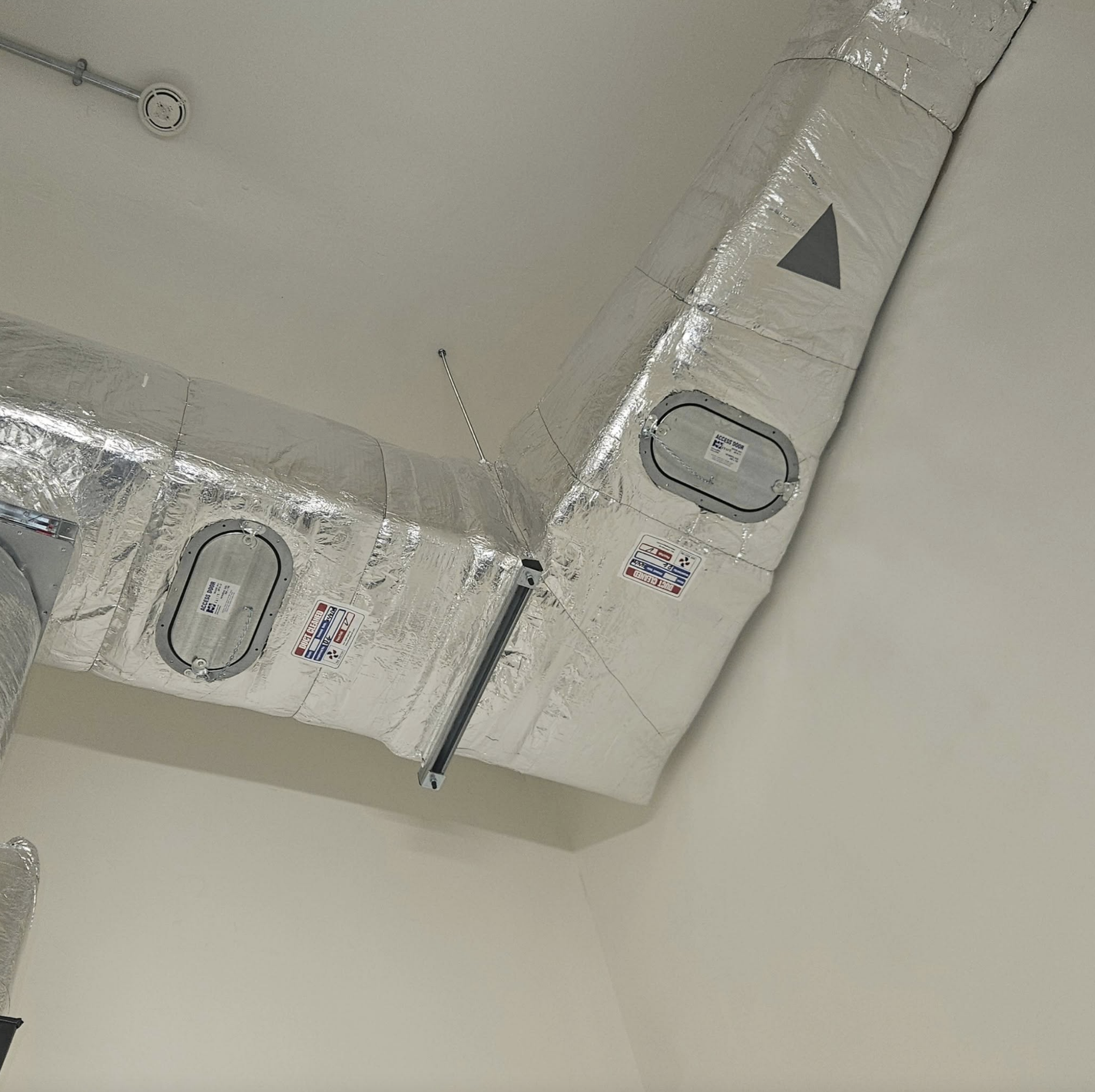 Insulated commercial ductwork with two maintenance access hatches